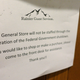 In this Saturday, Dec. 22, 2018, photo, a sign at the National Park Inn at Longmire at Mount Rainier National Park is displayed in Washington state and reads that the facility’s general store will not be staffed due to the partial U.S. government shutdown.